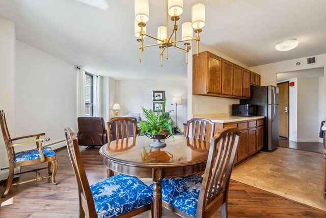 6615 Lake Shore Dr S Unit 601, Richfield, MN 55423 - dining space with baseboards, a chandelier, and visible vents