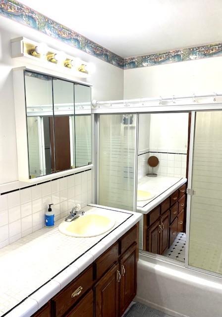 bathroom with decorative backsplash and vanity