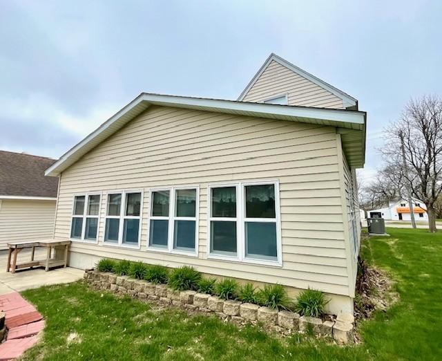rear view of house featuring a lawn and a patio area