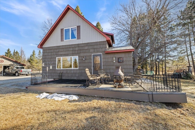 back of house featuring a wooden deck