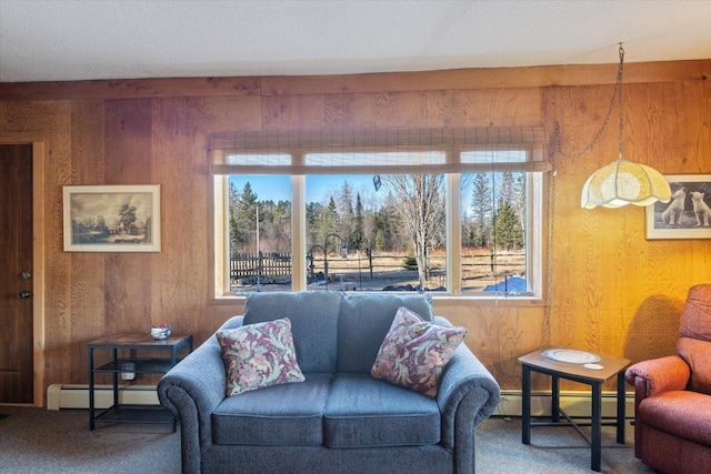 living room with baseboard heating, a baseboard radiator, carpet flooring, and wooden walls