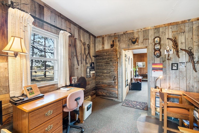 home office featuring wood walls and carpet flooring