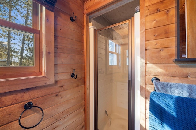 full bathroom with wooden walls and a stall shower
