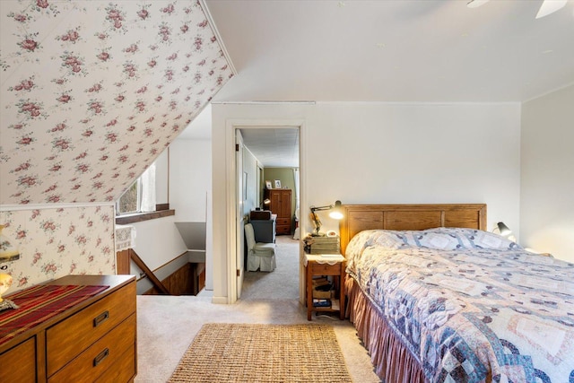 bedroom featuring wallpapered walls, baseboards, and light colored carpet