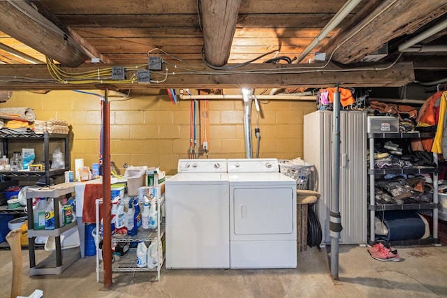 clothes washing area featuring washing machine and clothes dryer and laundry area