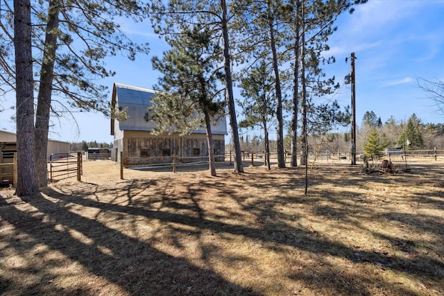 view of yard featuring an exterior structure, an outbuilding, and fence