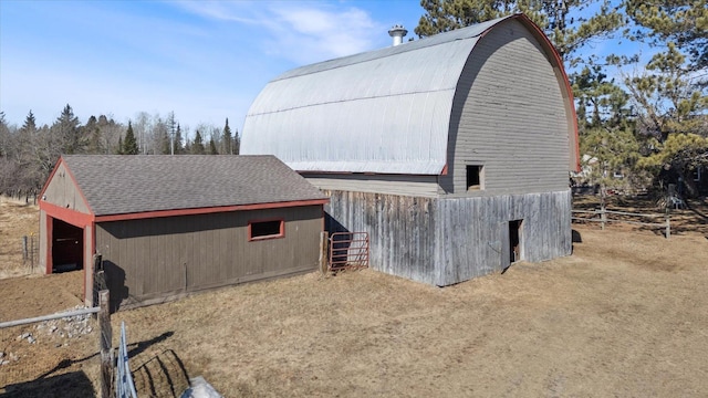 view of barn with fence