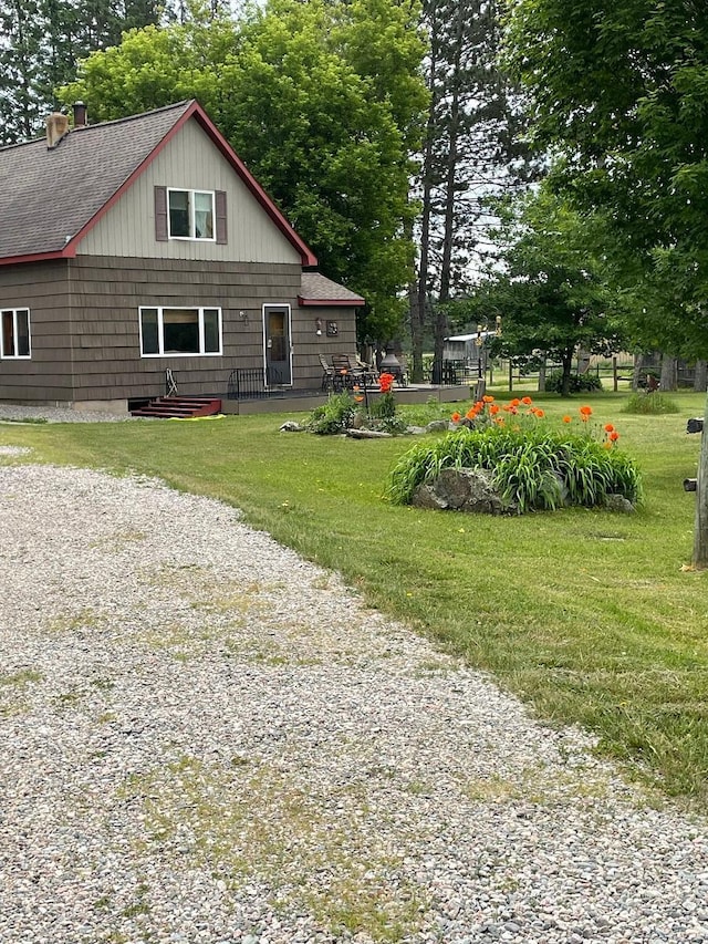 7500 Northfield Rd, Pike Twp, MN 55732 - back of property featuring roof with shingles, a chimney, and a yard