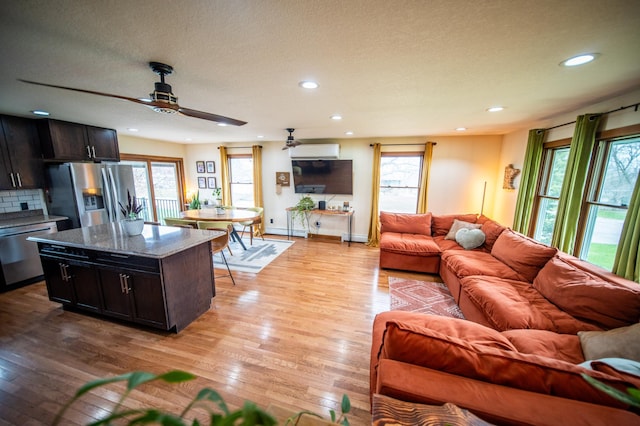 1474 Aldrich Ct, Faribault, MN 55021 - living area with recessed lighting, an AC wall unit, baseboards, ceiling fan, and light wood-style floors