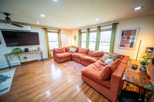 1474 Aldrich Ct, Faribault, MN 55021 - living area with wood finished floors, a baseboard radiator, ceiling fan, and recessed lighting