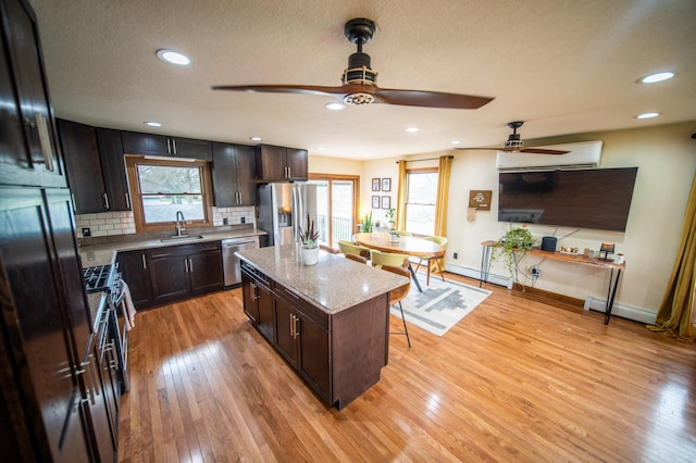 1474 Aldrich Ct, Faribault, MN 55021 - kitchen with a sink, stainless steel appliances, a ceiling fan, and a breakfast bar