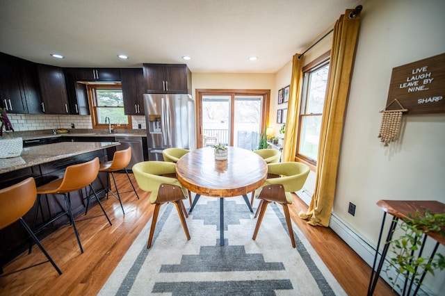 1474 Aldrich Ct, Faribault, MN 55021 - dining space with light wood-style flooring, recessed lighting, and a baseboard heating unit