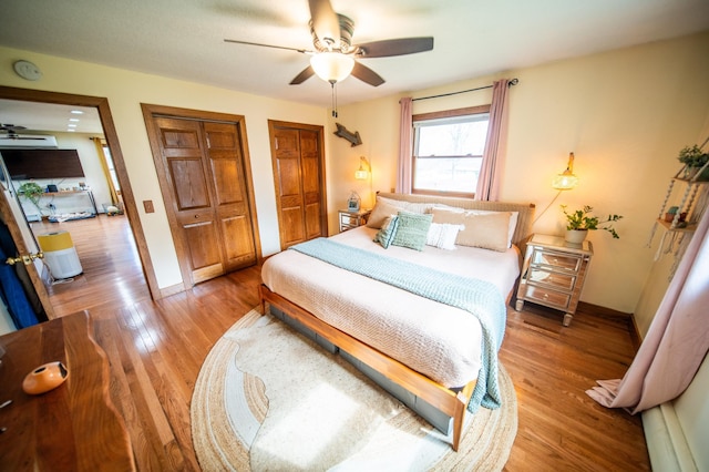 1474 Aldrich Ct, Faribault, MN 55021 - bedroom with two closets, baseboards, ceiling fan, and wood finished floors