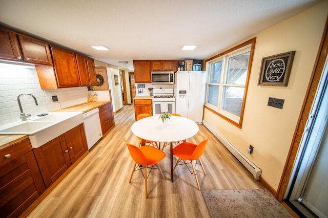 1474 Aldrich Ct, Faribault, MN 55021 - kitchen with a baseboard heating unit, white appliances, light wood-style flooring, and a sink