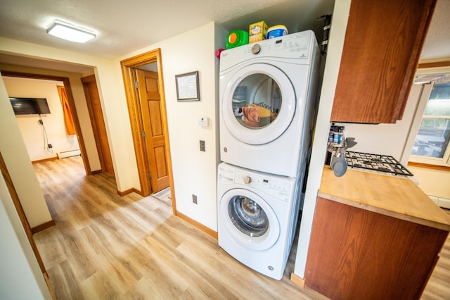 1474 Aldrich Ct, Faribault, MN 55021 - clothes washing area with stacked washer / dryer, light wood finished floors, laundry area, and baseboard heating