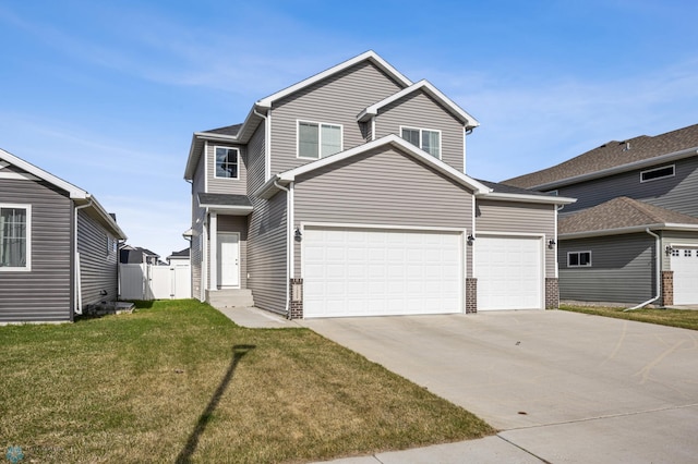 traditional-style home featuring concrete driveway, a gate, a front yard, fence, and a garage