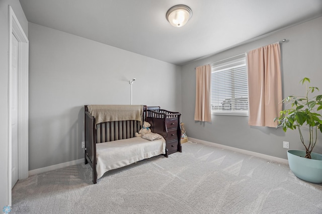 bedroom featuring baseboards and carpet