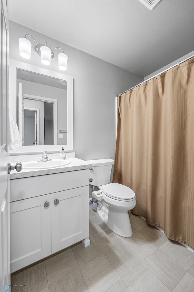 full bathroom featuring tile patterned floors, toilet, and vanity