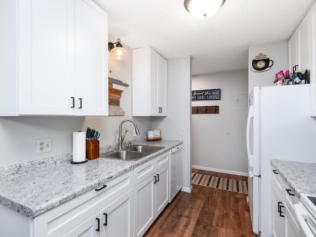 4001 Heritage Hills Dr Unit 105, Bloomington, MN 55437 - kitchen featuring white cabinets, a sink, dark wood-style flooring, freestanding refrigerator, and dishwasher