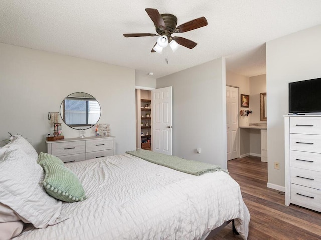 4001 Heritage Hills Dr Unit 105, Bloomington, MN 55437 - bedroom with connected bathroom, baseboards, a ceiling fan, and wood finished floors