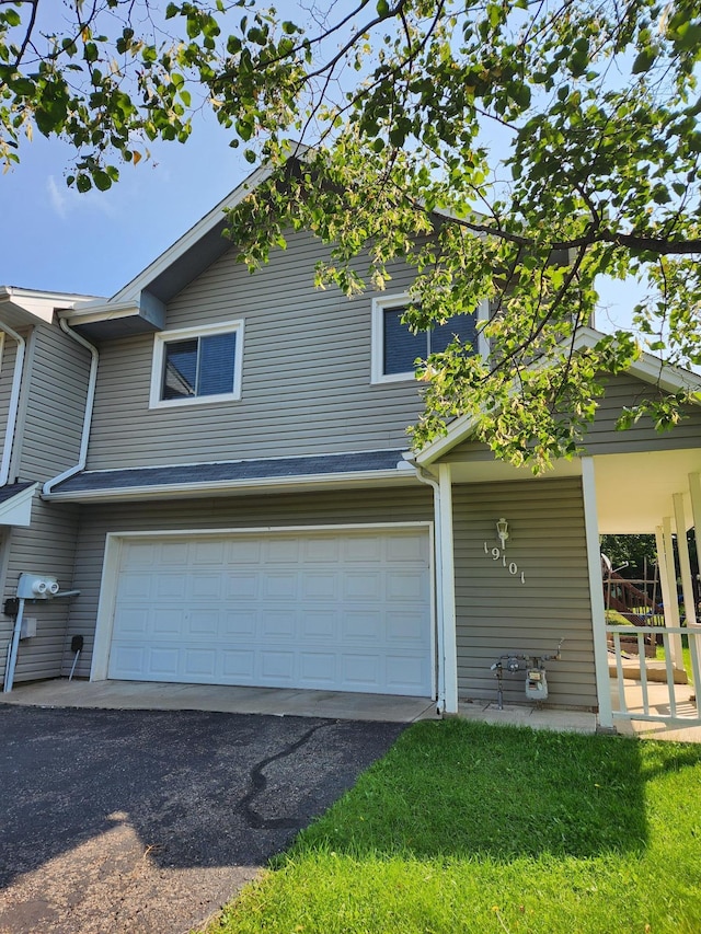 exterior space with a garage, covered porch, and driveway