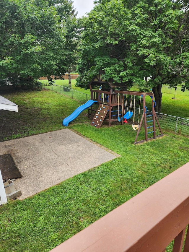 view of play area with a lawn and fence