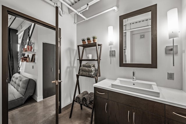 730 Stinson Blvd Unit 504, Minneapolis, MN 55413 - bathroom featuring finished concrete flooring, vanity, and baseboards