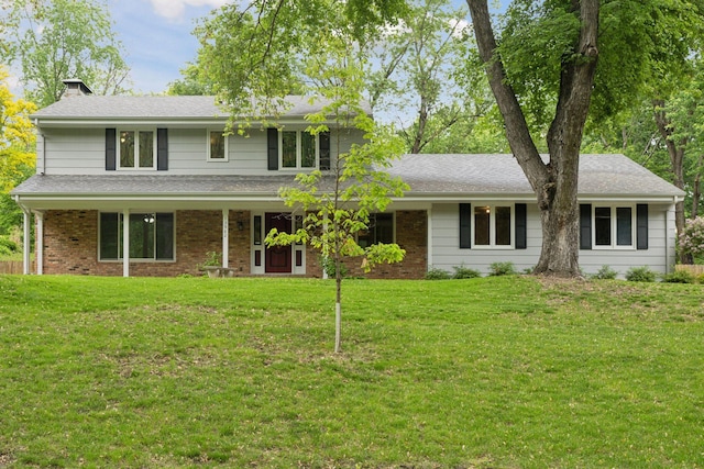 13982 Mount Ter, Minnetonka, MN 55345 - traditional home featuring a front yard, a chimney, and brick siding