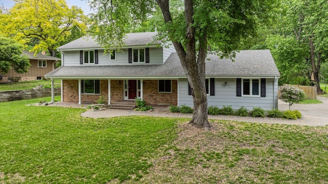 13982 Mount Ter, Minnetonka, MN 55345 - traditional-style home featuring a front yard, a shingled roof, brick siding, and covered porch