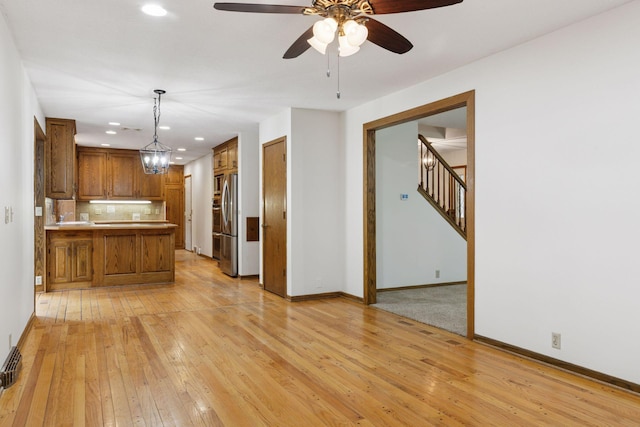 13982 Mount Ter, Minnetonka, MN 55345 - kitchen featuring freestanding refrigerator, brown cabinetry, light wood-style floors, a peninsula, and recessed lighting