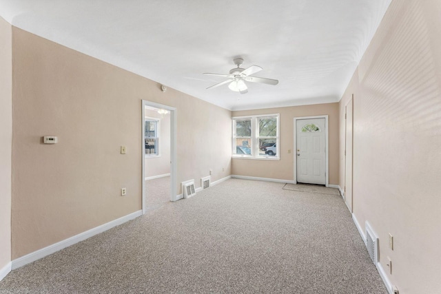 unfurnished room featuring light carpet, ceiling fan, and baseboards