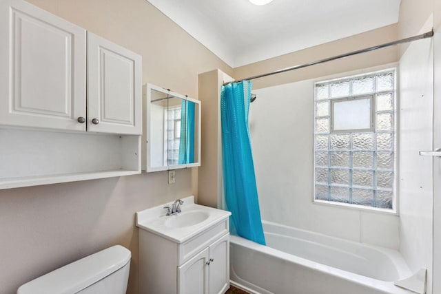bathroom with toilet, shower / bathtub combination with curtain, and vanity