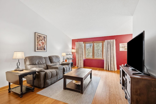living room featuring vaulted ceiling and light wood-type flooring