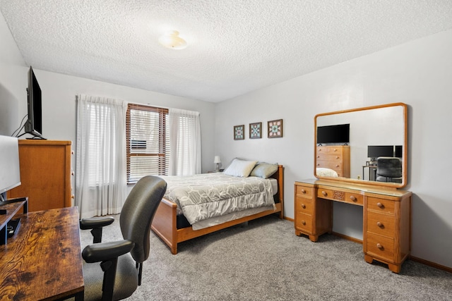 bedroom with a textured ceiling and light colored carpet