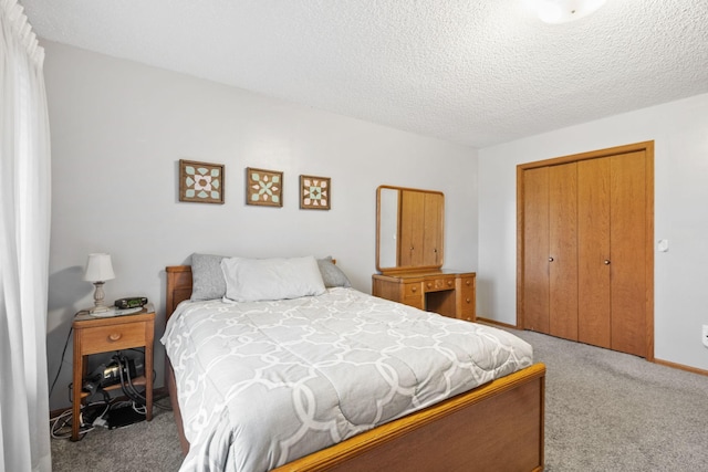 carpeted bedroom with a textured ceiling and a closet