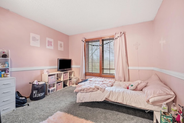 carpeted bedroom featuring a textured ceiling