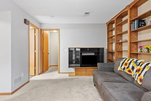 carpeted living room featuring baseboards and visible vents