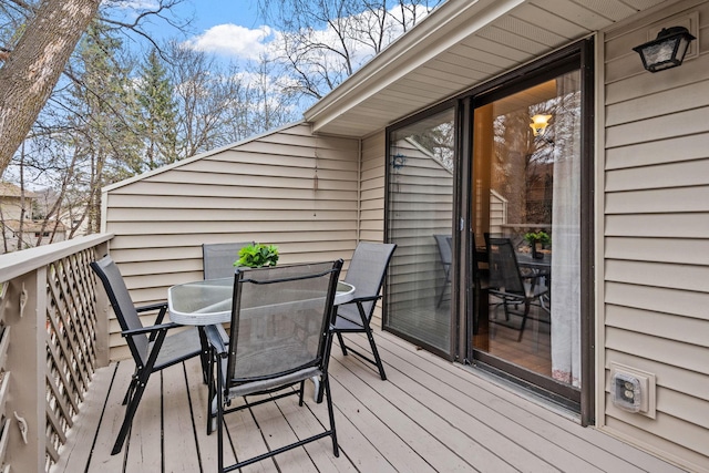 wooden terrace with outdoor dining area