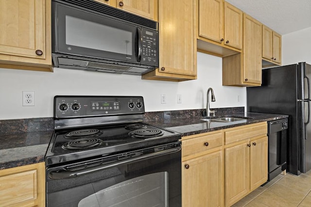 1502 5th St N Unit 401, Hopkins, MN 55305 - kitchen with dark stone counters, a sink, light tile patterned floors, black appliances, and light brown cabinets