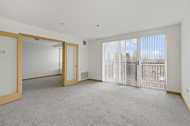 1502 5th St N Unit 401, Hopkins, MN 55305 - spare room featuring french doors, baseboards, carpet flooring, and visible vents
