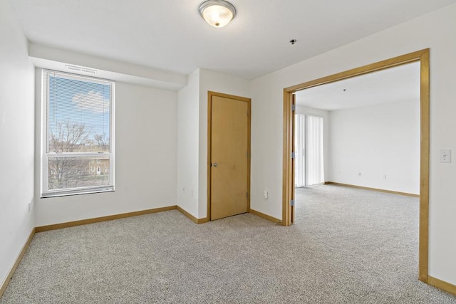 1502 5th St N Unit 401, Hopkins, MN 55305 - carpeted empty room featuring baseboards and visible vents