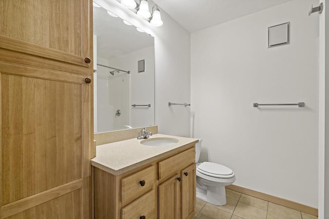 1502 5th St N Unit 401, Hopkins, MN 55305 - bathroom with tile patterned flooring, vanity, toilet, baseboards, and walk in shower