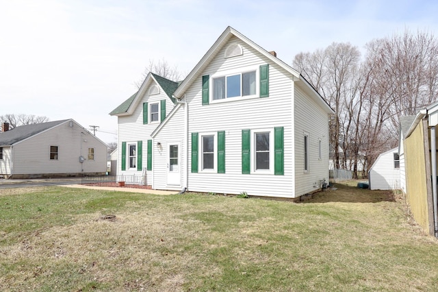 back of property with a yard