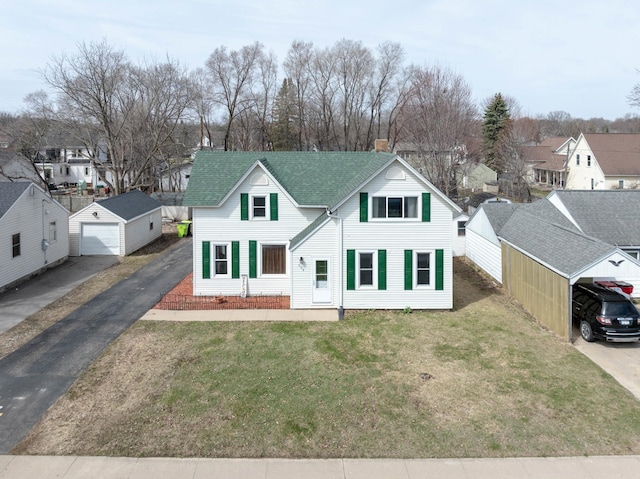 traditional-style house featuring a chimney, a shingled roof, a residential view, an outdoor structure, and a garage