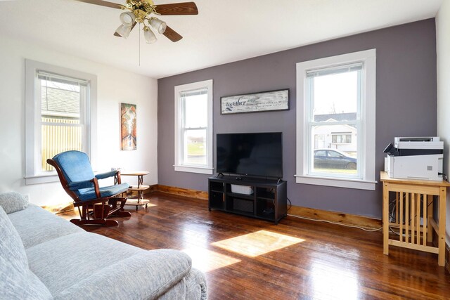living room with wood finished floors, baseboards, ceiling fan, and plenty of natural light