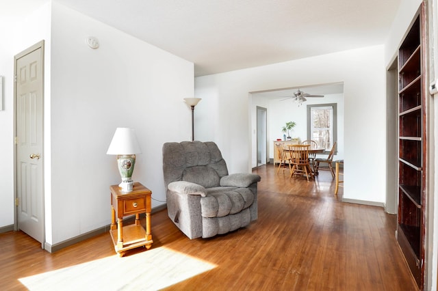 sitting room featuring a ceiling fan and wood finished floors