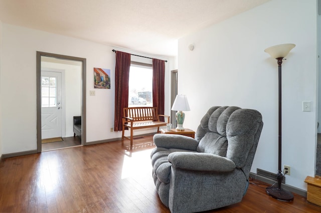 living area featuring wood finished floors and baseboards