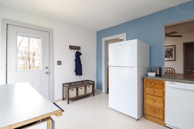 kitchen with light floors, ceiling fan, and white appliances