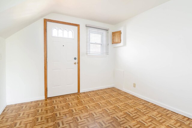 entrance foyer with lofted ceiling and baseboards