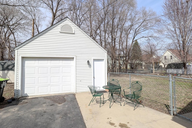 detached garage with fence and driveway